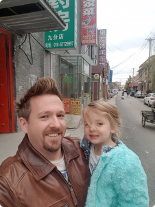 Adam with his daughter Asha in his neighbourhood.